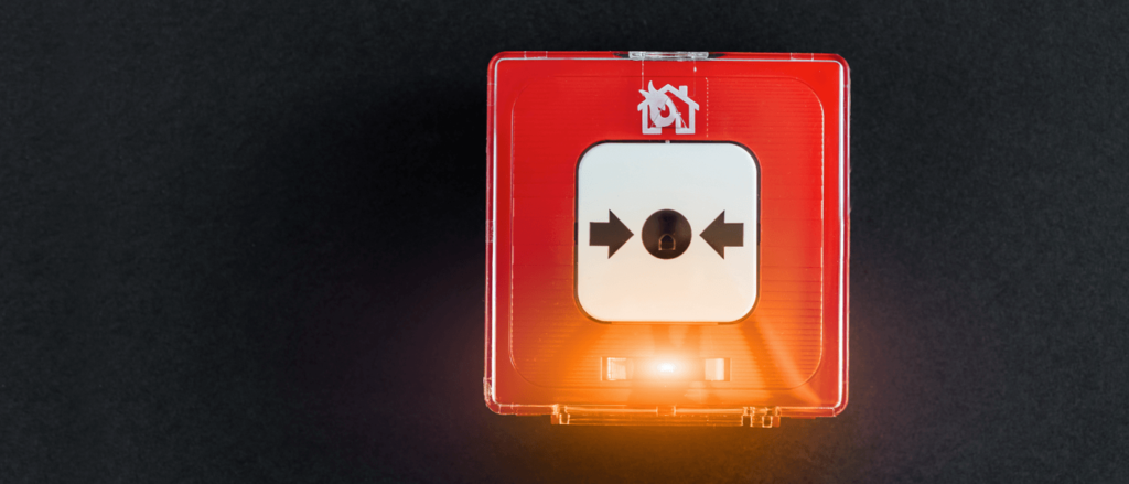 Beitragsbild zum Thema Wirk-Prinzipprüfung. Auf dem Bild ist ein roter Feueralarm-Knopf zu sehen.